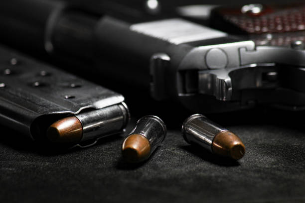 istock Automatic white gun stainless steel pistol weapon model m1911 with real bullet ammo in magazine with black background 1322793776