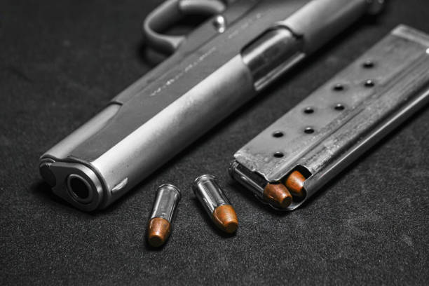 istock Automatic white gun stainless steel pistol weapon model m1911 with real bullet ammo and magazine with black background 1322793782
