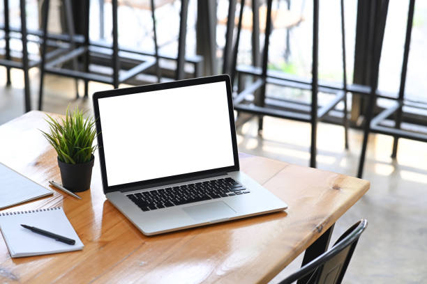 istock Computer laptop, houseplant and notebook on office desk. 1322794584