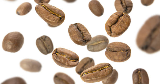 istock Coffee beans fly close-up on a white background. Levitation of coffee beans 1322794717