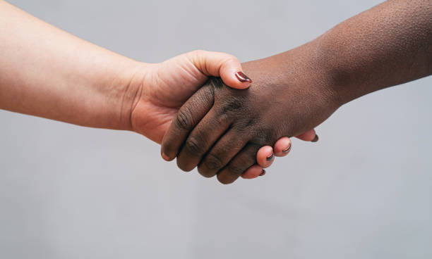 istock Multi race hands joined together, on a gray background. No racism - Empowerment and equal rights concept 1322795919