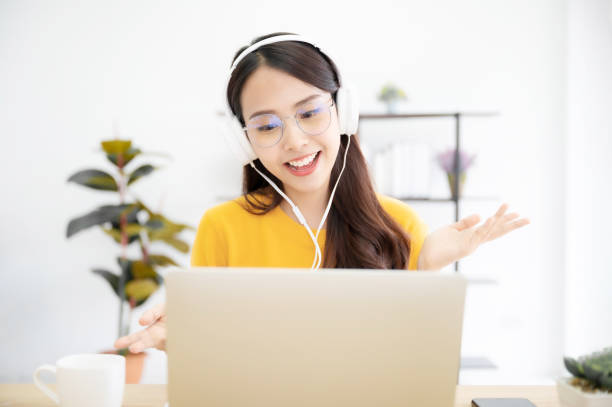 istock Happy young girl student studying at home, sitting at the desk, using laptop computer, having video chat, online learning homeschool 1322796911