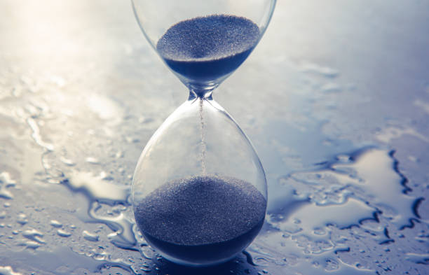 istock Hourglass on a light background. Time is money. Business solutions in time. 1322797754