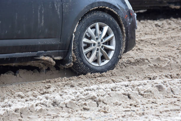 istock passenger car drives on a snowy road 1322798009
