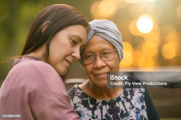 Mixed Race Woman Comforting Her Ill Mother Stock Photo - Download Image Now - Cancer - Illness, Senior Adult, Daughter