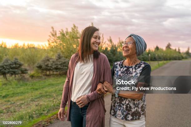 Beautiful Mixed Race Mother And Daughter Relaxing Outdoors Together Stock Photo - Download Image Now