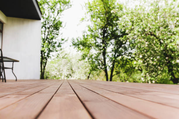 istock Sun rays on blurred view from wooden deck on balcony 1322803348