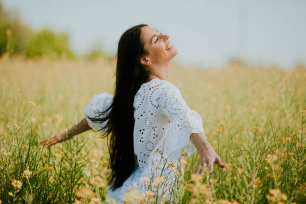 istock Young woman in the rapeseed field 1322803567