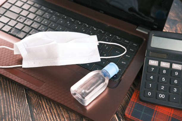 istock Surgical masks, hand sanitizer on office desk 1322807668