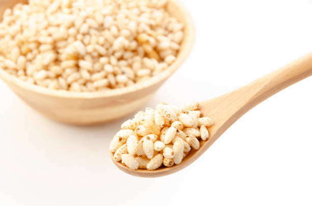 puffed rice on wooden spoon