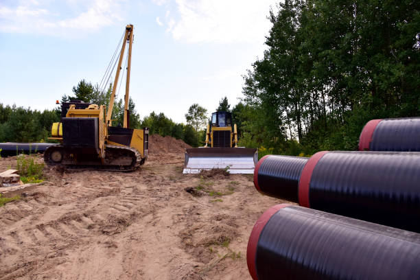 istock Natural gas pipeline construction work. Crawler crane with side boom Pipelayer Installation of  gas and crude oil pipes in ground 1322810020