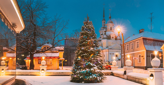 Parnu, Estonia - December 15, 2017: Christmas Tree In Holiday New Year Festive Illumination And St. Katherine Orthodox Church. Panorama.