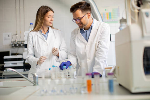 istock Group of young researchers analyzing chemical data in the laboratory 1322810997