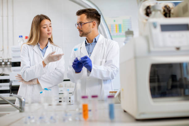 istock Group of young researchers analyzing chemical data in the laboratory 1322810999