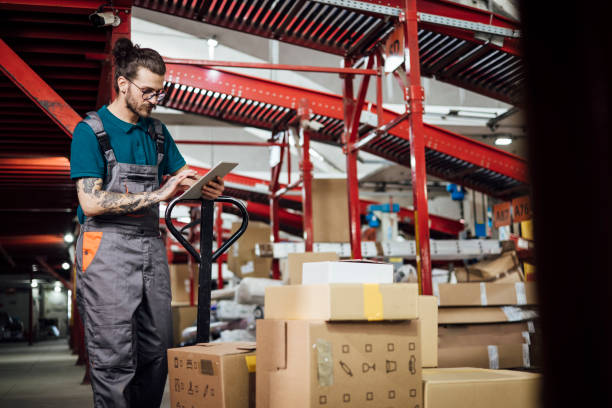 istock Portrait of a warehouse worker storing boxes and using a tablet 1322811063