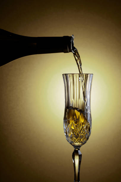 istock Sparkling wine is poured from a bottle into a glass. 1322811152
