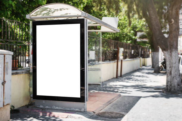 white blank vertical advertising billboard on street bus stop - bus stop imagens e fotografias de stock