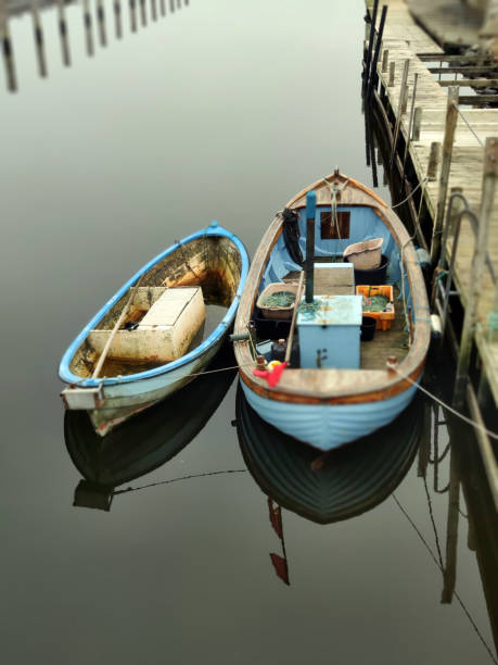 Two small fishing boats in shallow sea. Picturesque scene in Split, Croatia. Selective focus.