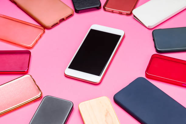 istock Choice of multicolored plastic back covers for mobile phones on pink background with a smart phone on the side 1322814130