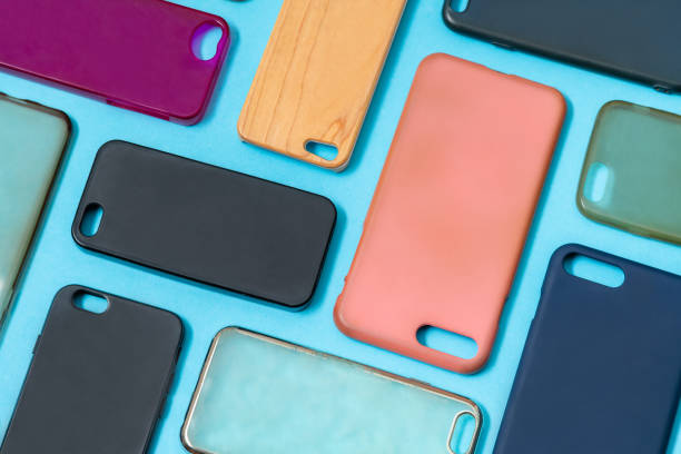 istock Pile of multicolored plastic back covers for mobile phone. Choice of smart phone protector accessories on blue background. A lot of silicone phone backs or skins next to each other 1322814365