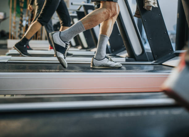 istock Unrecognizable man running on treadmill in a gym. 1322816192
