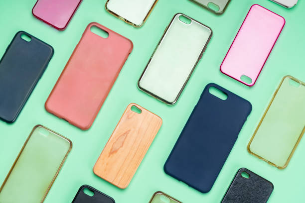 istock Pile of multicolored plastic back covers for mobile phone. Choice of smart phone protector accessories on green background. A lot of silicone phone backs or skins next to each other 1322816275