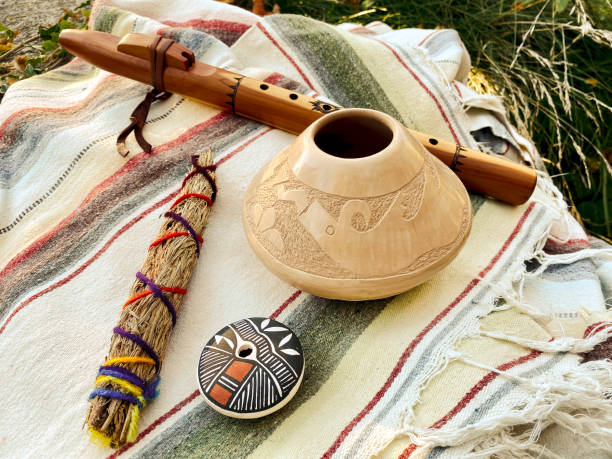 istock Flute, Smudge Stick and Two Seed Pots on a Cotton Blanket 1322816844
