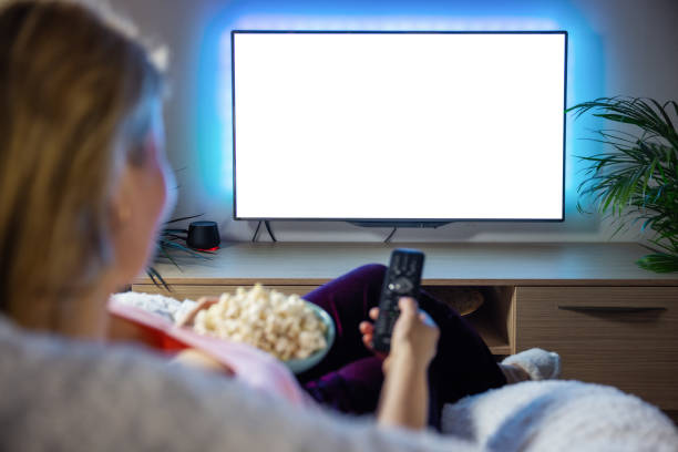 istock Woman watching TV with empty white scree 1322817768