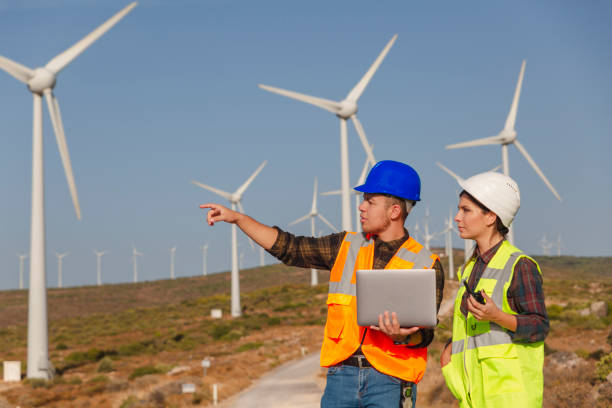 istock Young maintenance engineer team working in wind turbine farm 1322820438