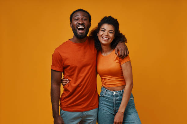 istock Beautiful young African couple looking at camera and smiling 1322820826