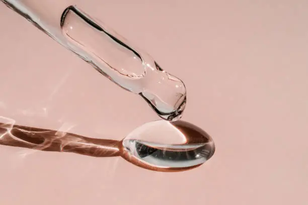 Photo of A drop of cosmetic oil falls from the pipette