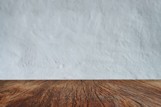 istock Empty wooden table and concrete wall texture and background with copy space. 1322823869