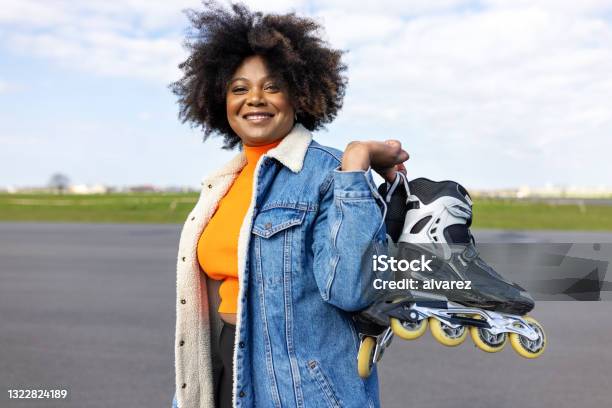 Happy African Female Skater On Airstrip Stock Photo - Download Image Now - Roller Skate, Roller Skating, Women