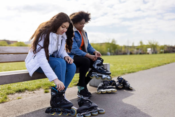 Female friends putting on roller skates