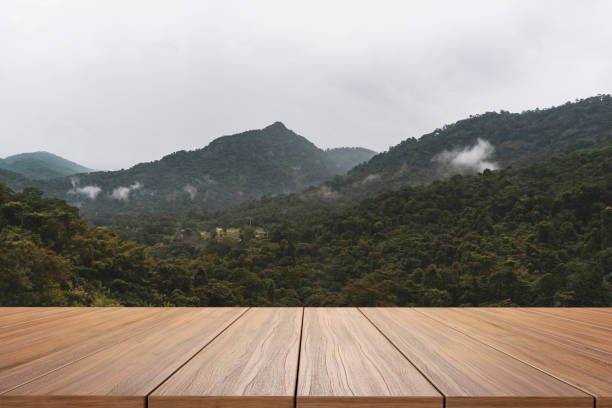 istock empty new wood table and mountain in background 1322825347