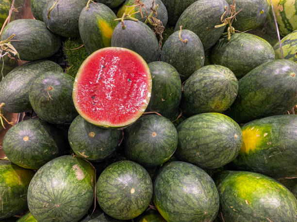 Pile of eclipse shaped red watermelon at fruit store