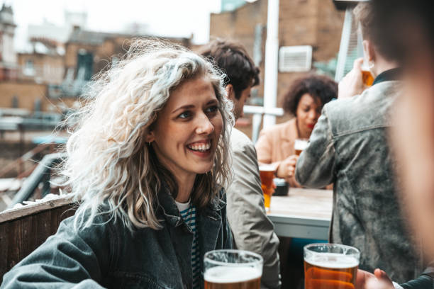 istock Group of happy friends having fun in a pub drinking ice cold beers 1322828103
