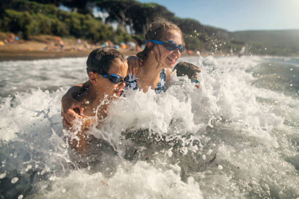 istock Children splashing in summer sea 1322828310