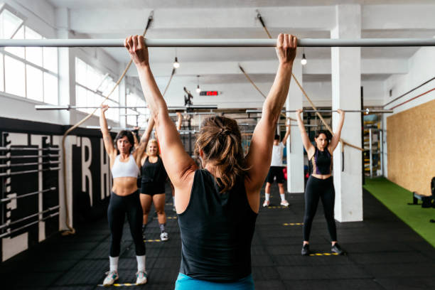 istock Coach Supervising Athletes In Gym 1322831305