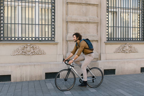 istock Side view of a handsome young businessman riding to work 1322832092