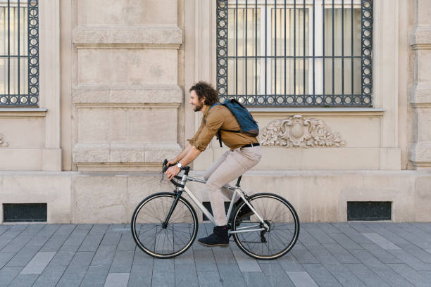 istock Active young adult commuting to work on his bicycle 1322832197