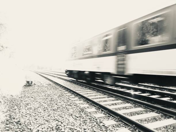 Futuristic spead motion concepts A high speed train passing by during a sunset black and white instant print stock pictures, royalty-free photos & images