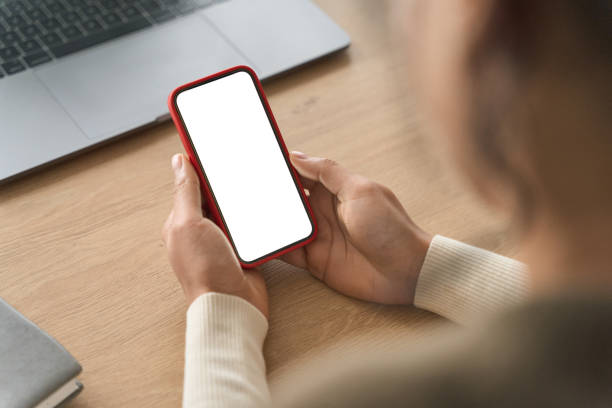 istock Over shoulder view of white blank empty mockup cell screen for advertising. 1322837681