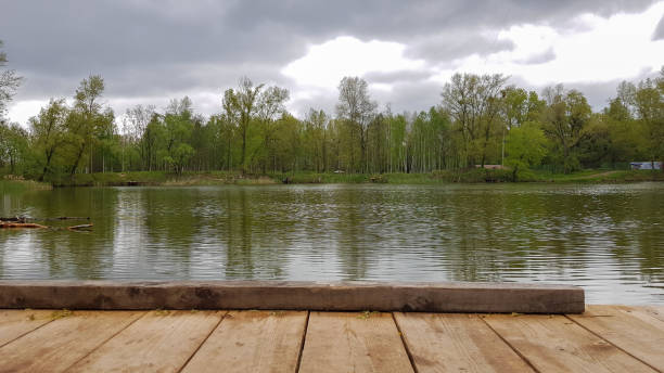 istock Reflection Natural Landscape View. Old wooden jetty, deck or pier in the lake. Nice looping background. 1322838538