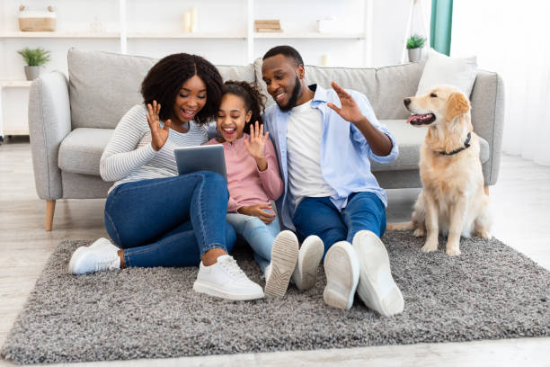 istock Black family having videocall using laptop waving hands 1322838637