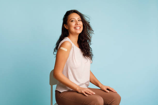 istock Joyful Female Showing Vaccinated Arm Over Blue Background In Studio 1322838873