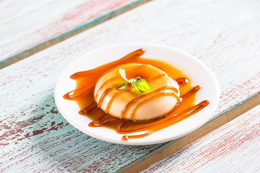 Caramel cubes with caramel sauce isolated on white background.