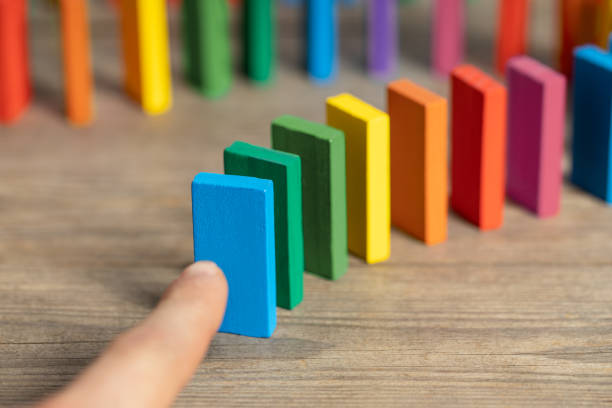 istock Finger pushing colorful domino 1322840910