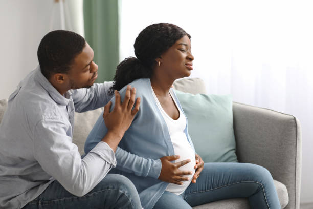 istock Worried expecting lady suffering from cramp, touching her big belly 1322841351