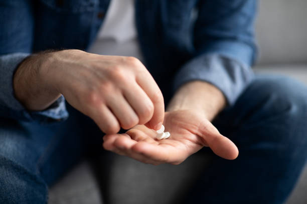 istock Unrecognizable man holding medicine in his hands 1322842698